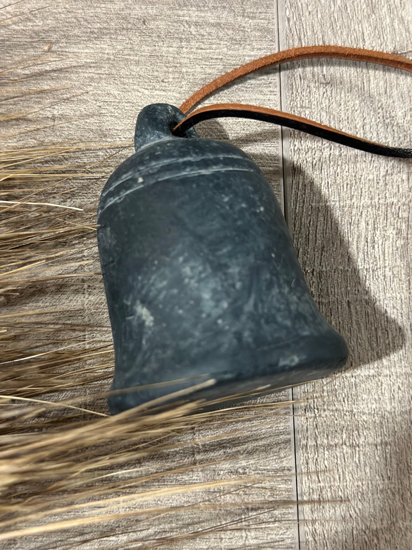 Small cement bell on string