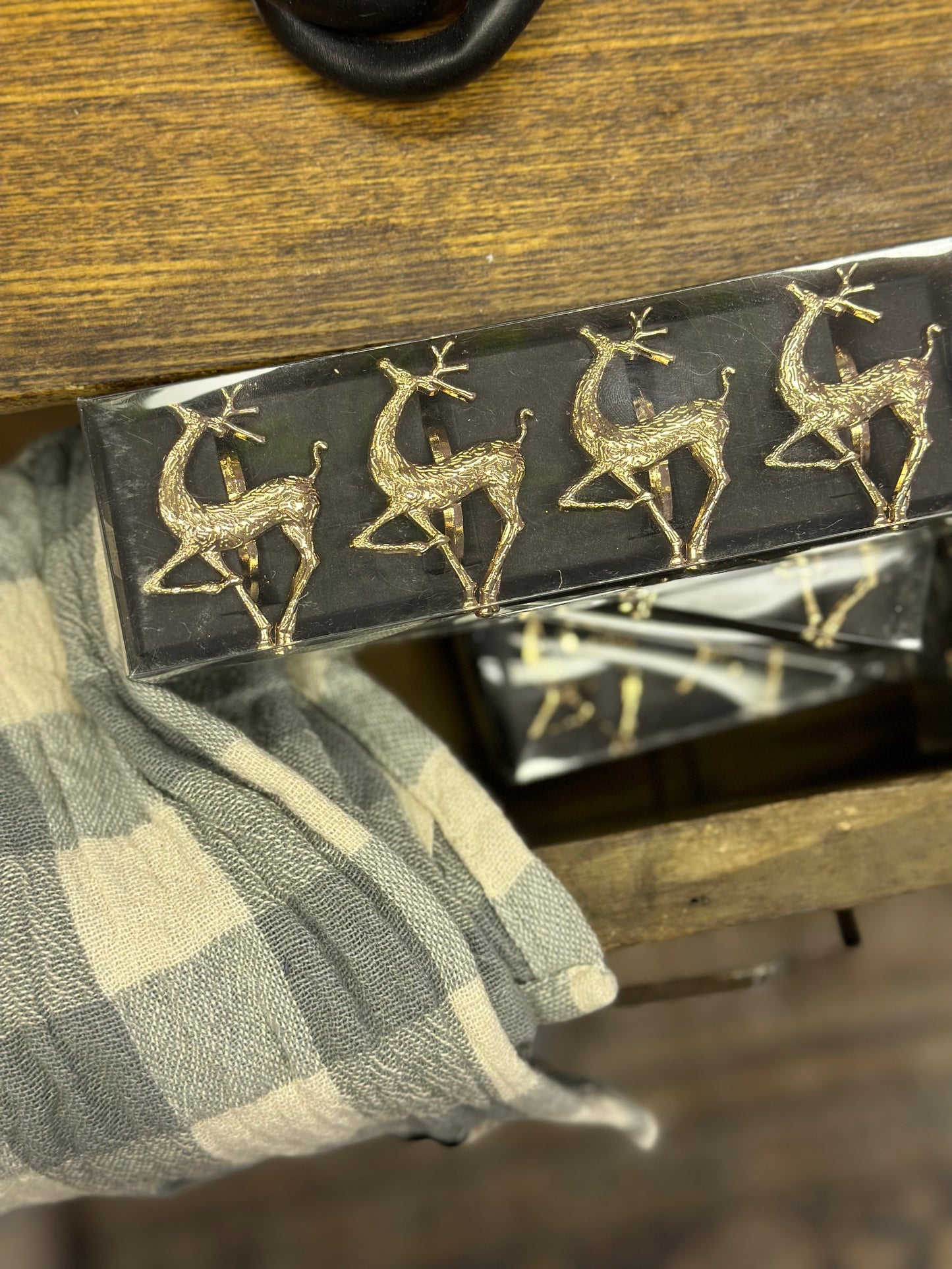Set of four gold reindeer napkin rings