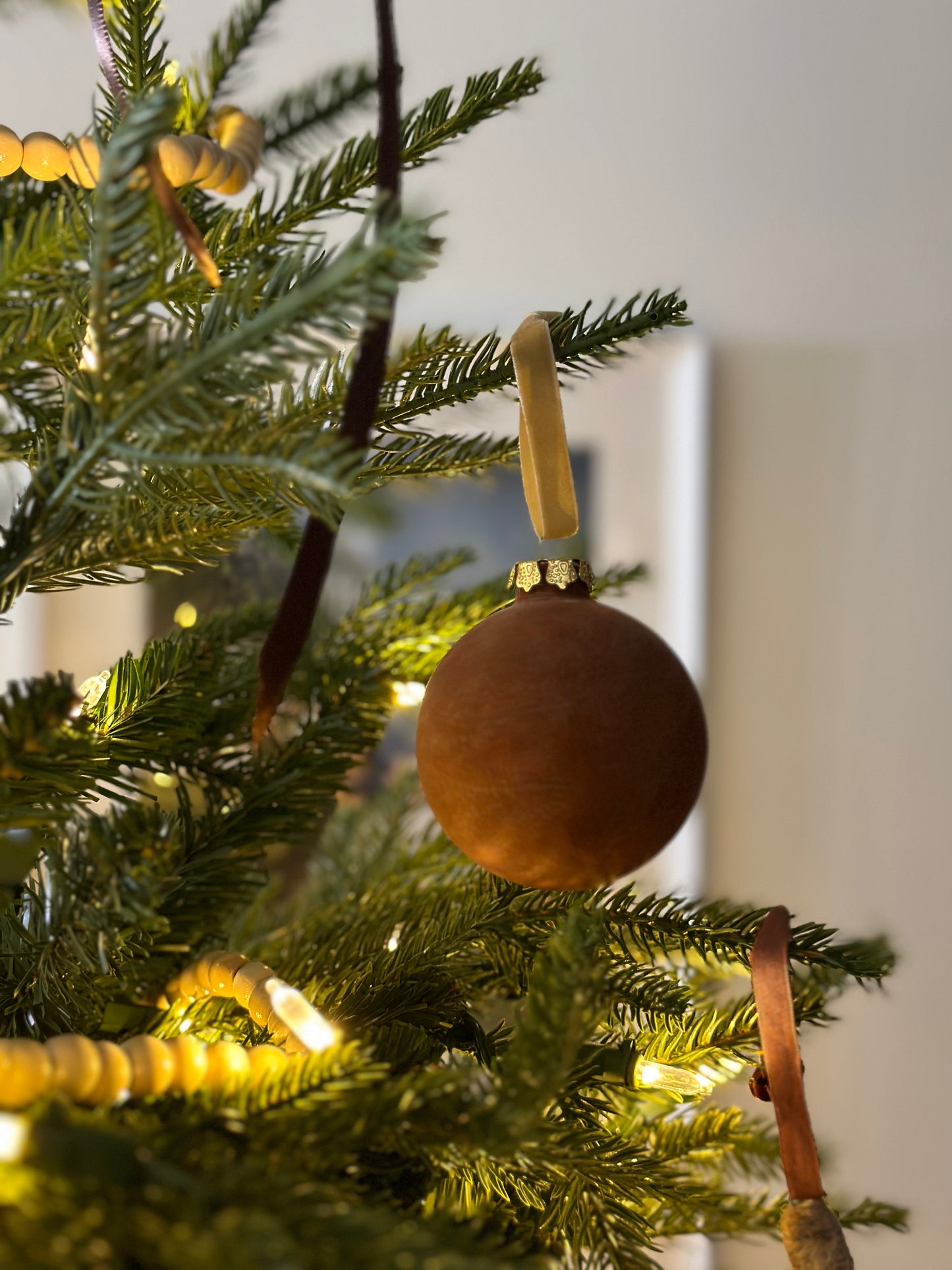 Brown velvet ornament on string