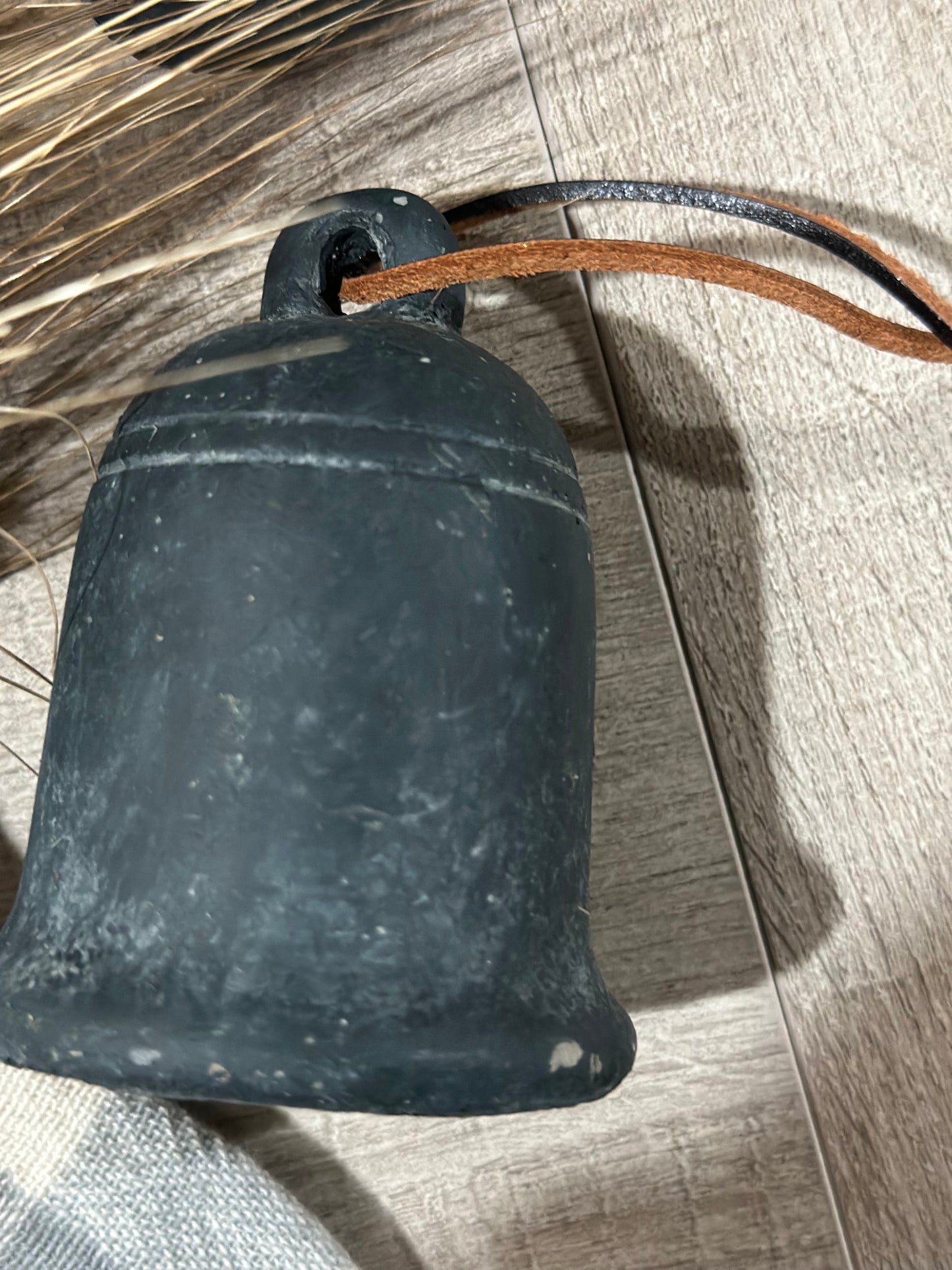 Cement bell on leather string