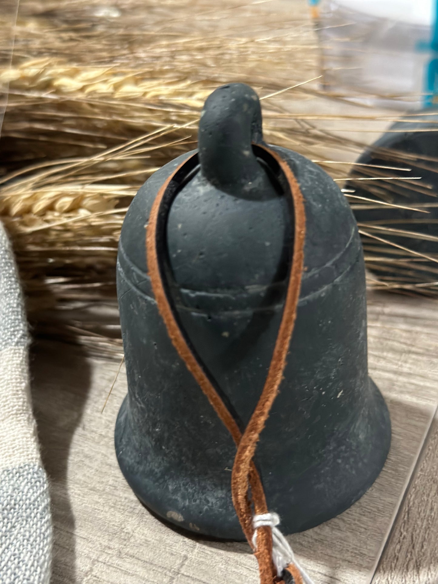 Cement bell on leather string