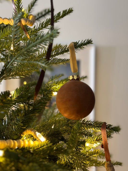 Brown velvet ornament on string